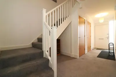 a staircase in a home with a white stair case at Signature - Oatlands House in Glasgow