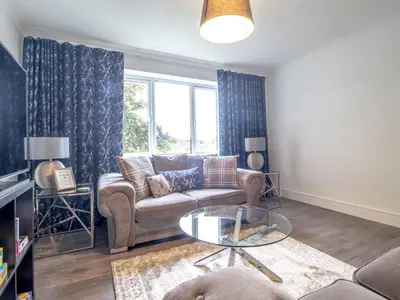 a living room with a couch and a glass table at Renfrew Town Centre Easy Link to Glasgow City - Pass the Keys in Renfrew
