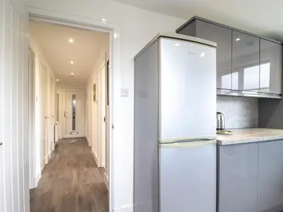 a kitchen with a refrigerator and a hallway at Renfrew Town Centre Easy Link to Glasgow City - Pass the Keys in Renfrew