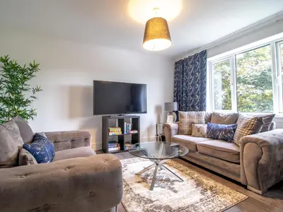 a living room with two couches and a tv at Renfrew Town Centre Easy Link to Glasgow City - Pass the Keys in Renfrew