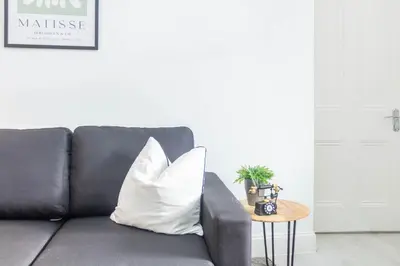 a black couch with a white pillow on a table at Renton Apartment in Renton