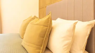 a group of pillows sitting on top of a bed at Renton Apartment in Renton
