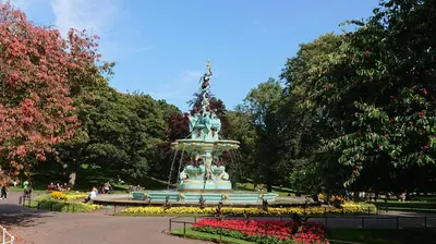 a fountain in the middle of a park at Violet Bank Apartment Morningside in Edinburgh