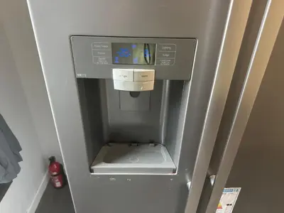 a refrigerator with a drink dispenser in it at The Schoolhouse Largs in Largs