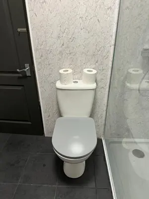 a bathroom with a toilet with two rolls of toilet paper at The Schoolhouse Largs in Largs