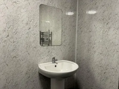 a bathroom with a sink and a mirror on the wall at The Schoolhouse Largs in Largs