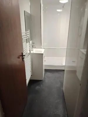 a white bathroom with a sink and a mirror at Bright Edinburgh Flat - City Center EB7 in Edinburgh