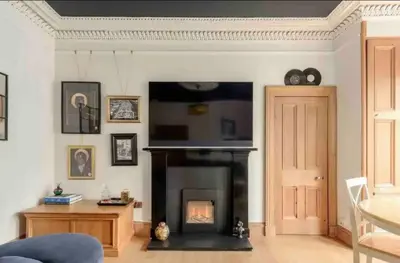 a living room with a fireplace and a tv at amazing apartments - Avondale Pl by Stockbridge in Edinburgh