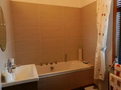 a bathroom with a bath tub and a sink at Goatfell View in Brodick