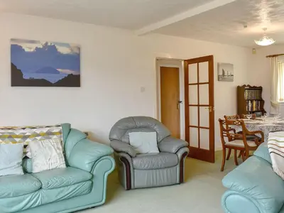 a living room with two chairs and a table at The Willows in Brodick