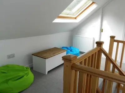 a room with a staircase and a skylight at Craigard Cottage in Corrie