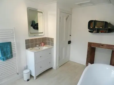 a white bathroom with a sink and a mirror at Craegard House in Corrie