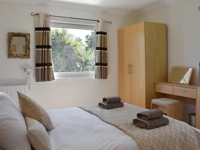 a bedroom with a bed with two towels on it at Fellview in Brodick