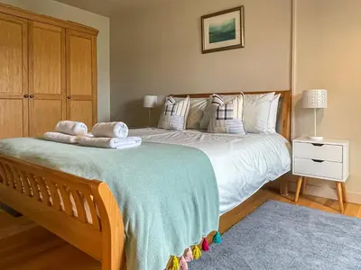 a bedroom with a large bed with towels on it at Hollinhaven in Blackwaterfoot