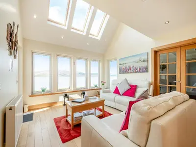 a living room with a couch and a table at Sky View in Ardmaleish