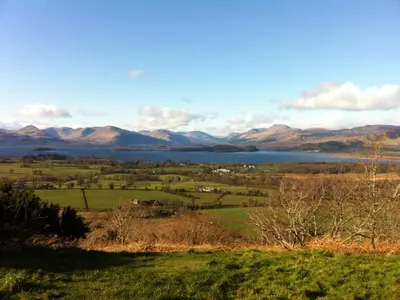 a view of a lake with mountains in the background at Crosskeys Cottage in Shandon