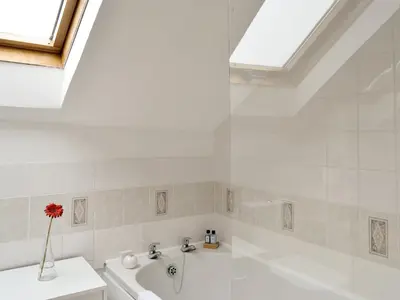 a bathroom with a white tub and a sink at Apartment Sea View in Hunters Quay