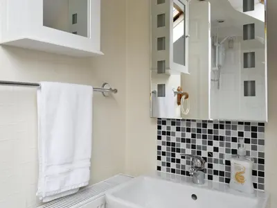 a bathroom with a sink and a toilet and a mirror at Apartment Sea View in Hunters Quay
