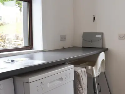 a bathroom with a desk with a printer on it at Park House in Blackwaterfoot
