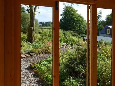 a view from a window of a garden at Old Steading in Brodick