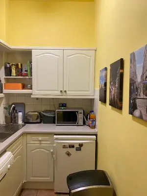 a small kitchen with white cabinets and a microwave at Central Room In Historic Tenement Shared Apartment Near Old Town in Edinburgh