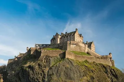 a castle sitting on top of a mountain at Cozy Castle view flat in Edinburgh EB9 in Edinburgh