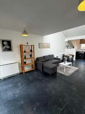 a living room with a couch and a table at Victoria Street View Flat in Edinburgh EB10 in Edinburgh
