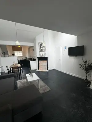a living room with a couch and a fireplace at Victoria Street View Flat in Edinburgh EB10 in Edinburgh