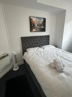 a bed with two pillows on it in a bedroom at Victoria Street View Flat in Edinburgh EB10 in Edinburgh