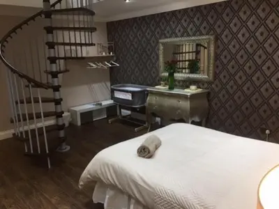 a bedroom with a staircase and a bed and a desk at Brig O'Doon 1 in Ayr