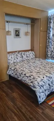 a bed in a room with a large bed sidx sidx sidx at 223 Websters land - stunning castle view in Edinburgh
