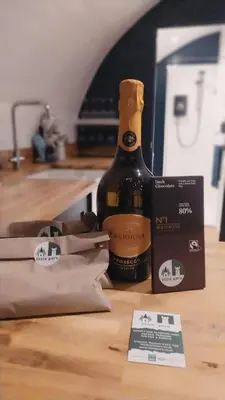 a bottle of wine sitting on a counter next to a box at little peru luxury pods and alpaca farm in Crosshill