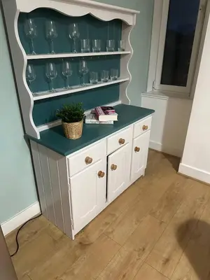 a white cabinet with a shelf with glasses on it at Clydebank Cozy 3bdr flat near Glasgow in Clydebank