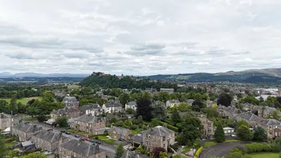 an aerial view of a city with houses and trees at 19 Snowdon Apartment in Stirling