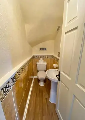 a small bathroom with a toilet and a sink at Loch Lomond 2 Bedroom Apartment in Tarbet