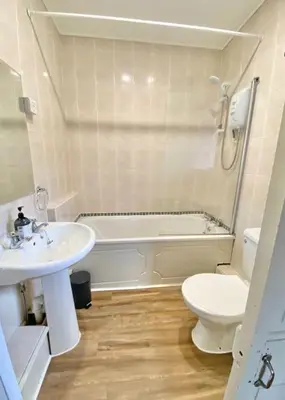 a bathroom with a sink and a toilet and a tub at Loch Lomond 2 Bedroom Apartment in Tarbet
