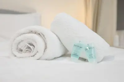 a stack of towels and a tube of toothpaste at Two Bedroom Apartment-Central Edinburgh-Old Town-licensed in Edinburgh