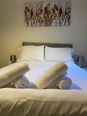 a bedroom with a bed with two towels on it at Two Bedroom Apartment-Central Edinburgh-Old Town-licensed in Edinburgh