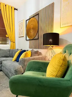 a living room with a green couch and yellow pillows at Two Bedroom Apartment-Central Edinburgh-Old Town-licensed in Edinburgh