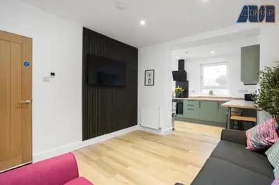 a living room with a couch and a flat screen tv at High Street Haven in Kincardine in Kincardine