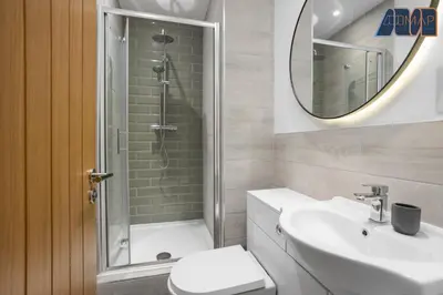 a bathroom with a shower and a toilet and a sink at High Street Haven in Kincardine in Kincardine
