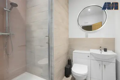 a bathroom with a shower and a toilet and a sink at High Street Haven in Kincardine in Kincardine