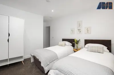 two beds in a bedroom with white walls at High Street Haven in Kincardine in Kincardine