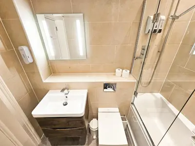 a bathroom with a sink and a toilet and a shower at Spacious 2 Bedroom Apartment in the heart of New Town in Edinburgh