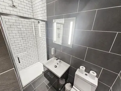 a bathroom with a sink and a toilet and a mirror at Spacious 2 Bedroom Apartment in the heart of New Town in Edinburgh
