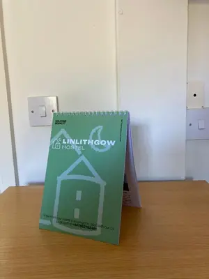 a green book sitting on top of a table at Linlithgow Hostel in Linlithgow