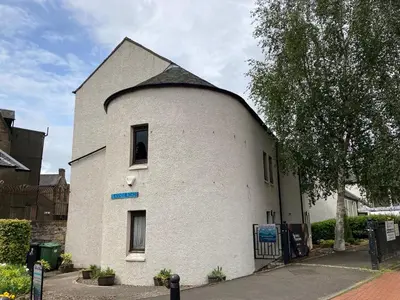 a small white building with a gambrel roof at Linlithgow Hostel in Linlithgow