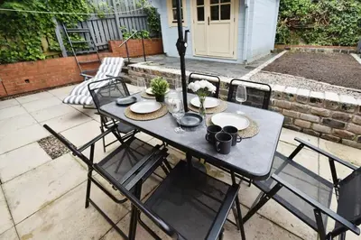 a table and chairs on a patio at Modern house near Glasgow 3bdr in Dalmuir