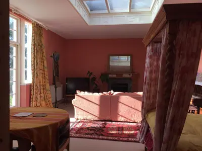 a living room with a couch and a tv at Gilchristland Organic Farm Retreat in Closeburn