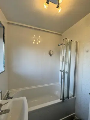 a bathroom with a tub and a sink and a shower at Seaside Apartment in Helensburgh